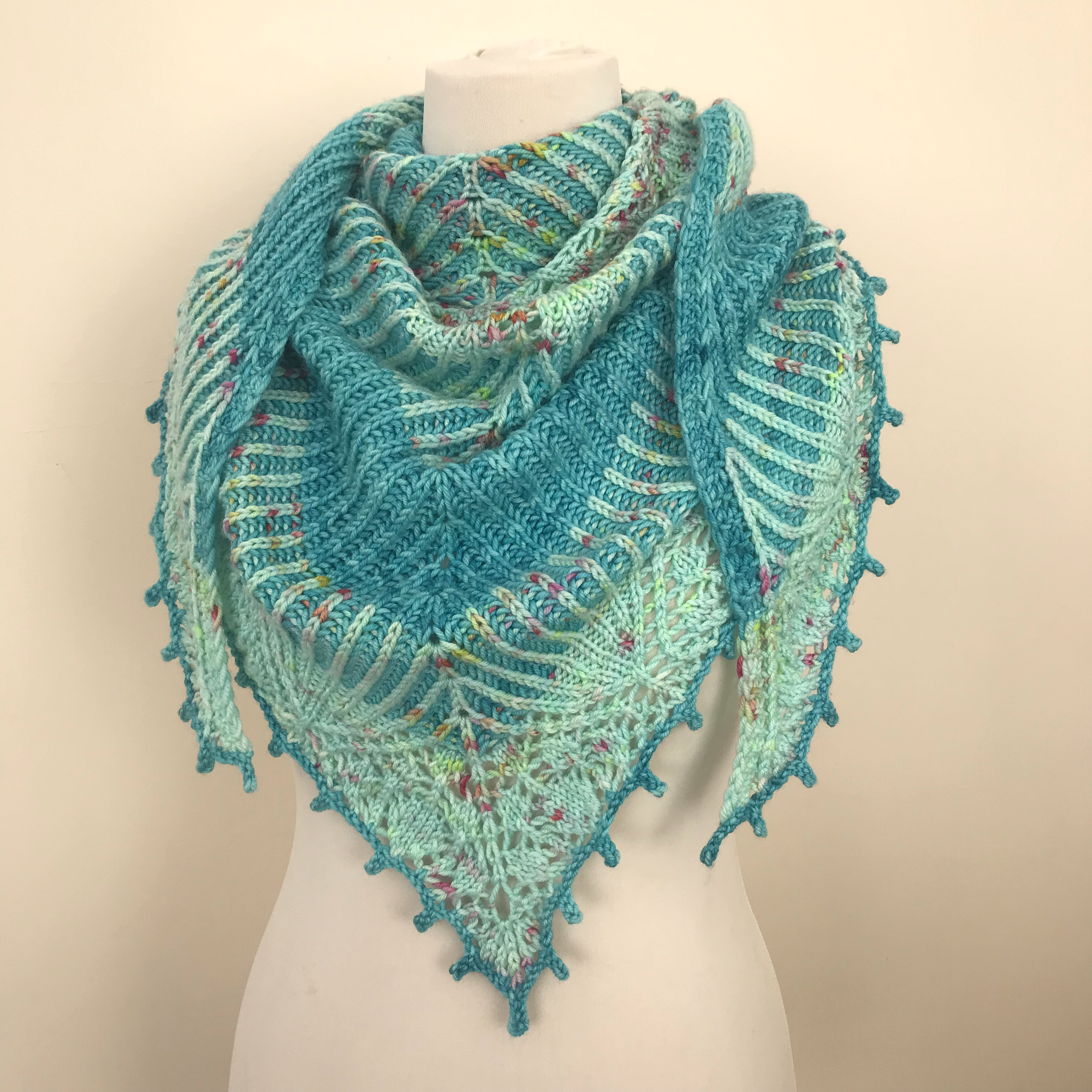 Triangular brioche and lace shawl pictured on a mannequin